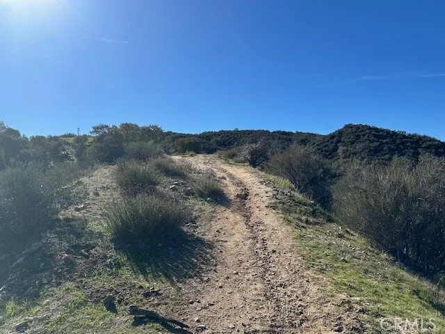 a view of mountain with sunset in background