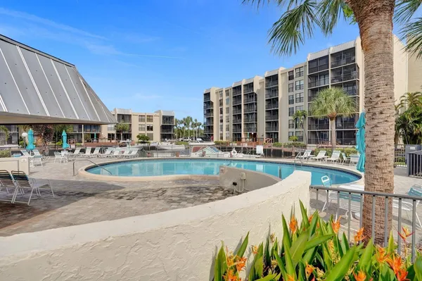 a swimming pool with an outdoor space and seating