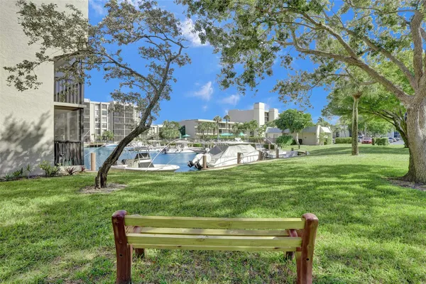a swimming pool with outdoor seating and a garden