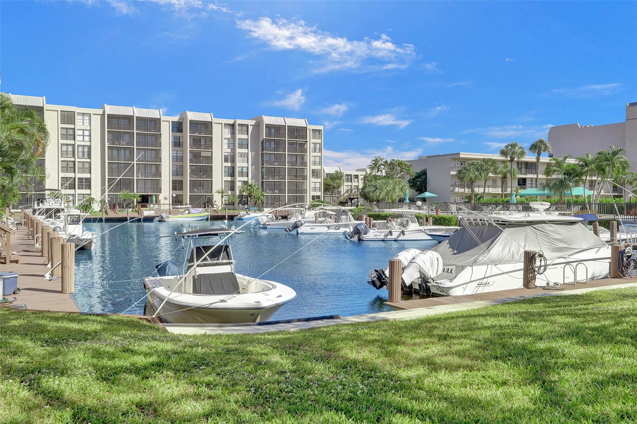 4 Royal Palm Way, Unit 503 Boca Raton, FL 33432 - Photo 35 of 36 a swimming pool with outdoor seating and a garden