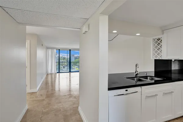 a kitchen with a sink and white cabinets