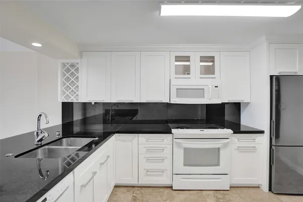 a kitchen with a sink stove and microwave