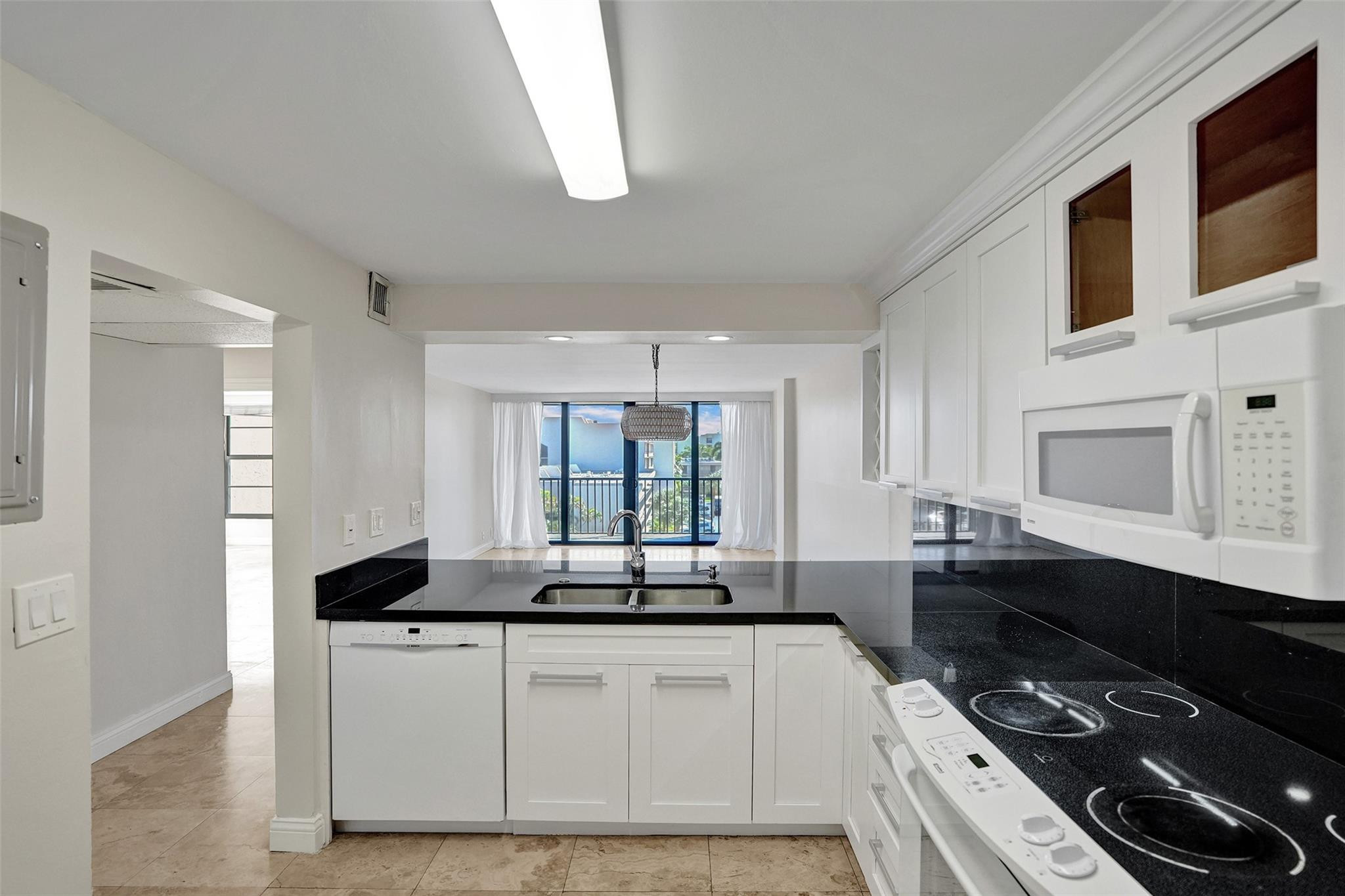 4 Royal Palm Way, Unit 503 Boca Raton, FL 33432 - Photo 8 of 36 a kitchen with a sink stove and microwave