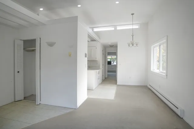 en empty room with windows and bathroom