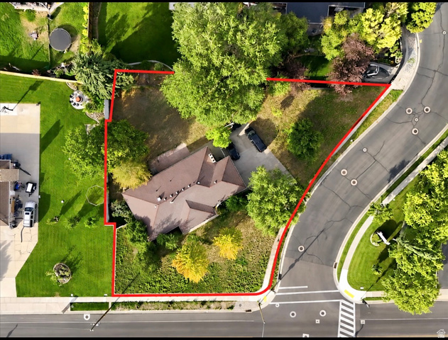 2455 South Bluff Road Syracuse, UT 84075 - Photo 6 of 35 Spacious corner lot featuring mature trees, a multi-gabled roofline, and a paved driveway