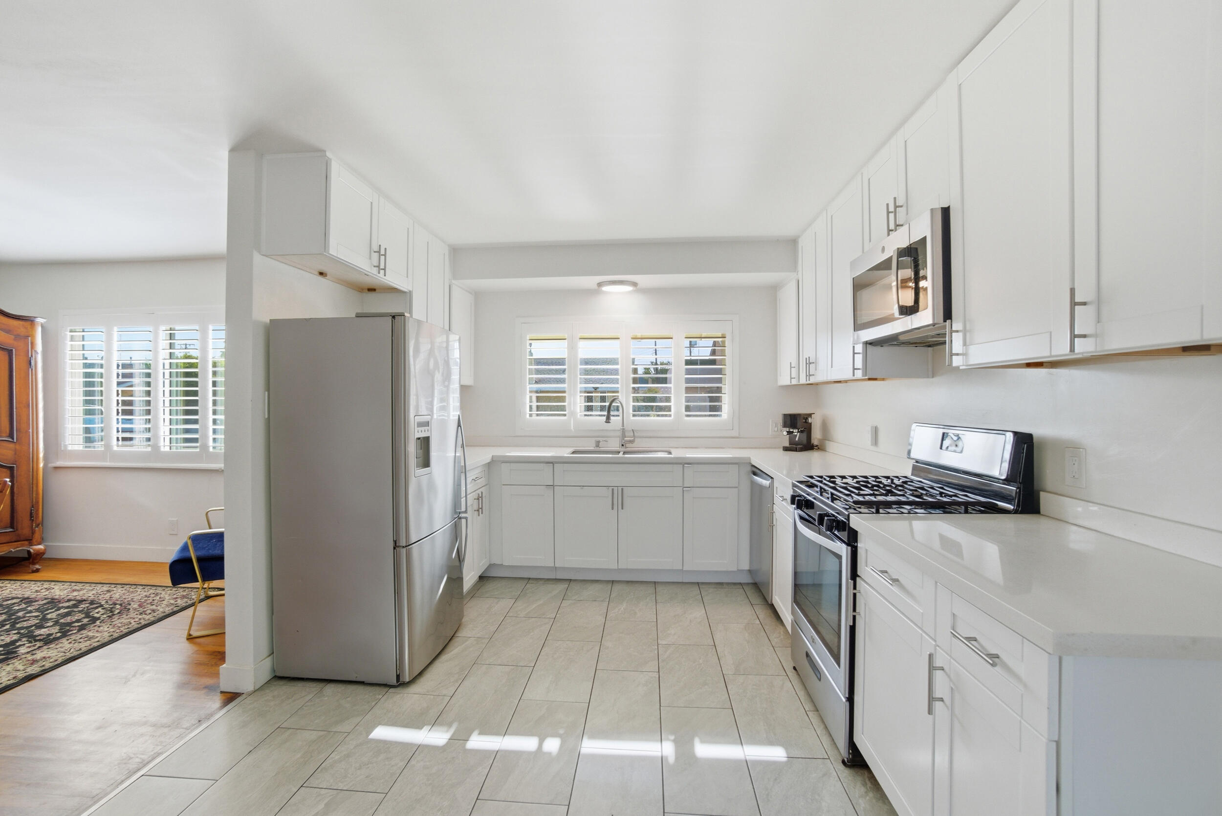 700 North M Street Oxnard, CA 93030 - Photo 11 of 35 a kitchen with a stove a sink and a refrigerator