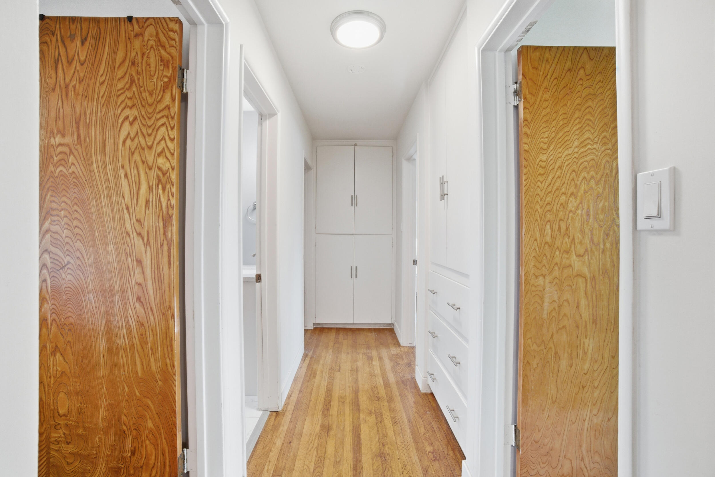 700 North M Street Oxnard, CA 93030 - Photo 14 of 35 a view of a hallway with wooden floor and a bathroom