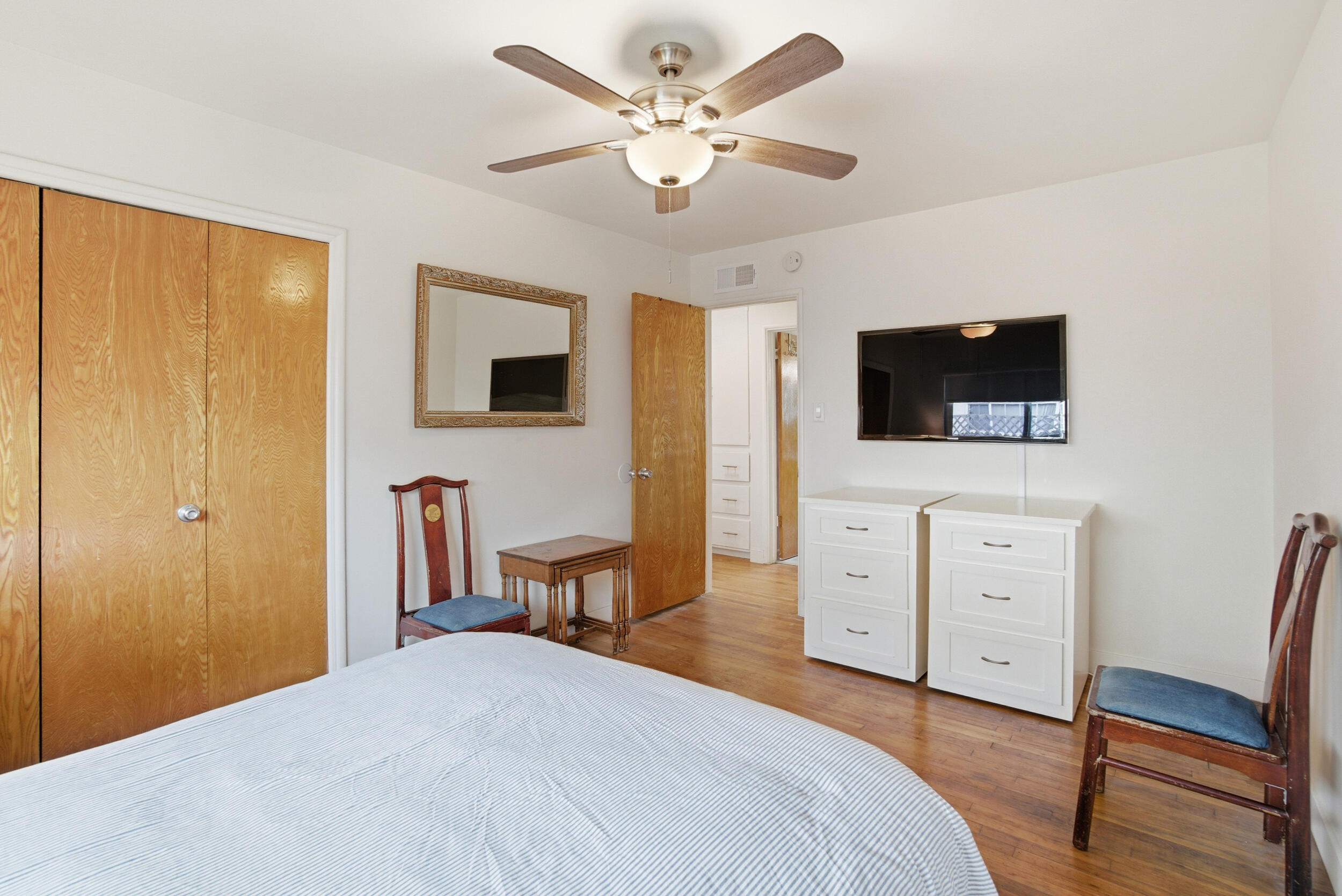 700 North M Street Oxnard, CA 93030 - Photo 22 of 35 a spacious bedroom with a bed and a flat screen tv