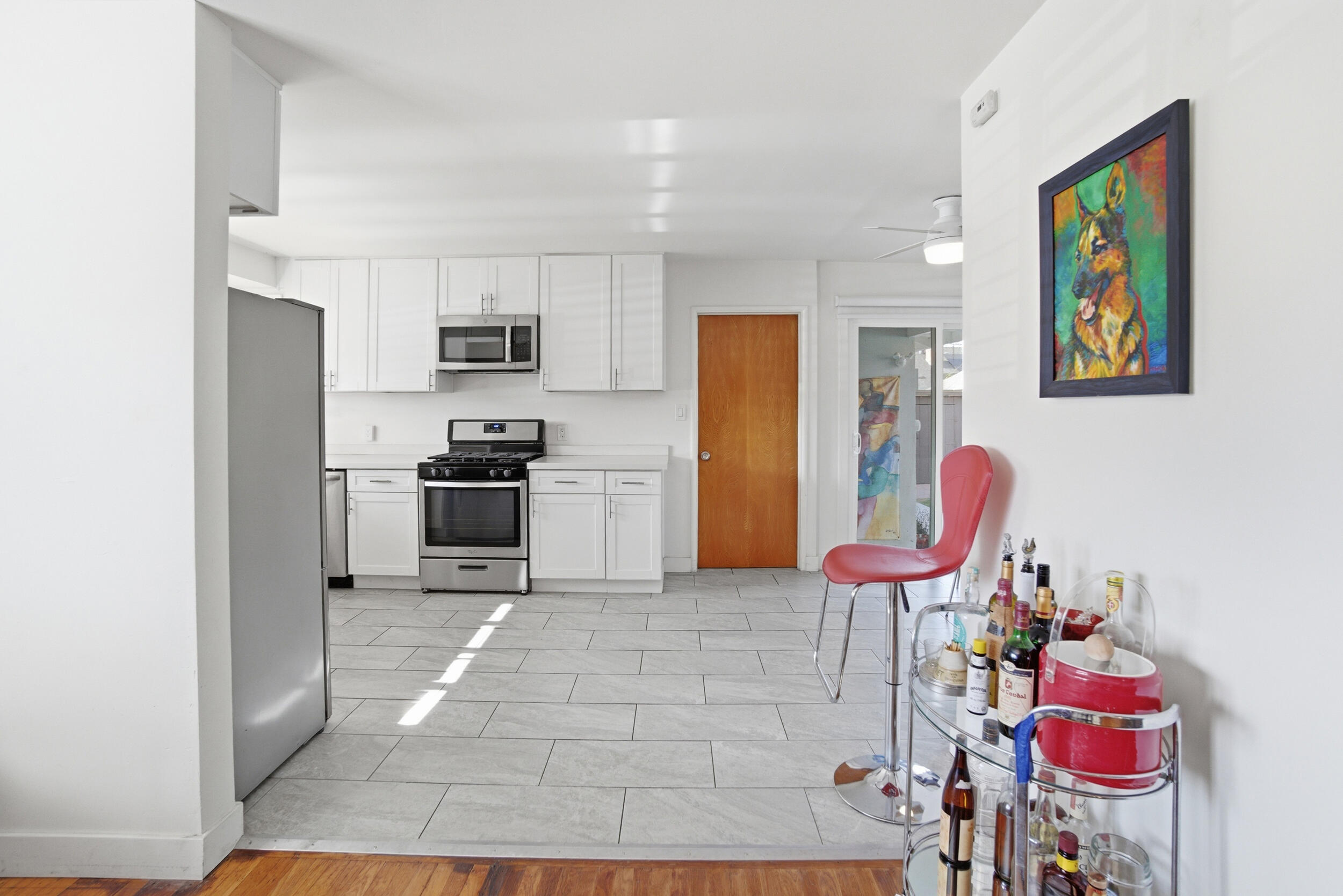 700 North M Street Oxnard, CA 93030 - Photo 10 of 35 a kitchen with stainless steel appliances kitchen island granite countertop a refrigerator and a sink