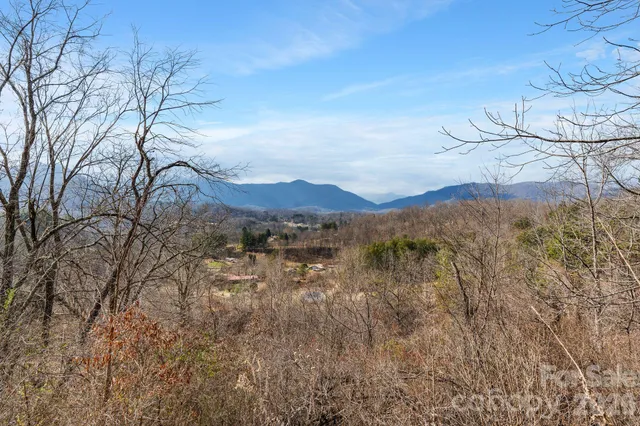 a view of mountain with sunset in background
