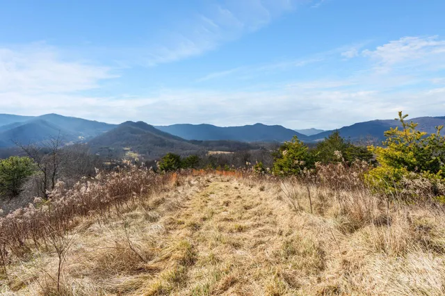 a view of mountain with sunset in background