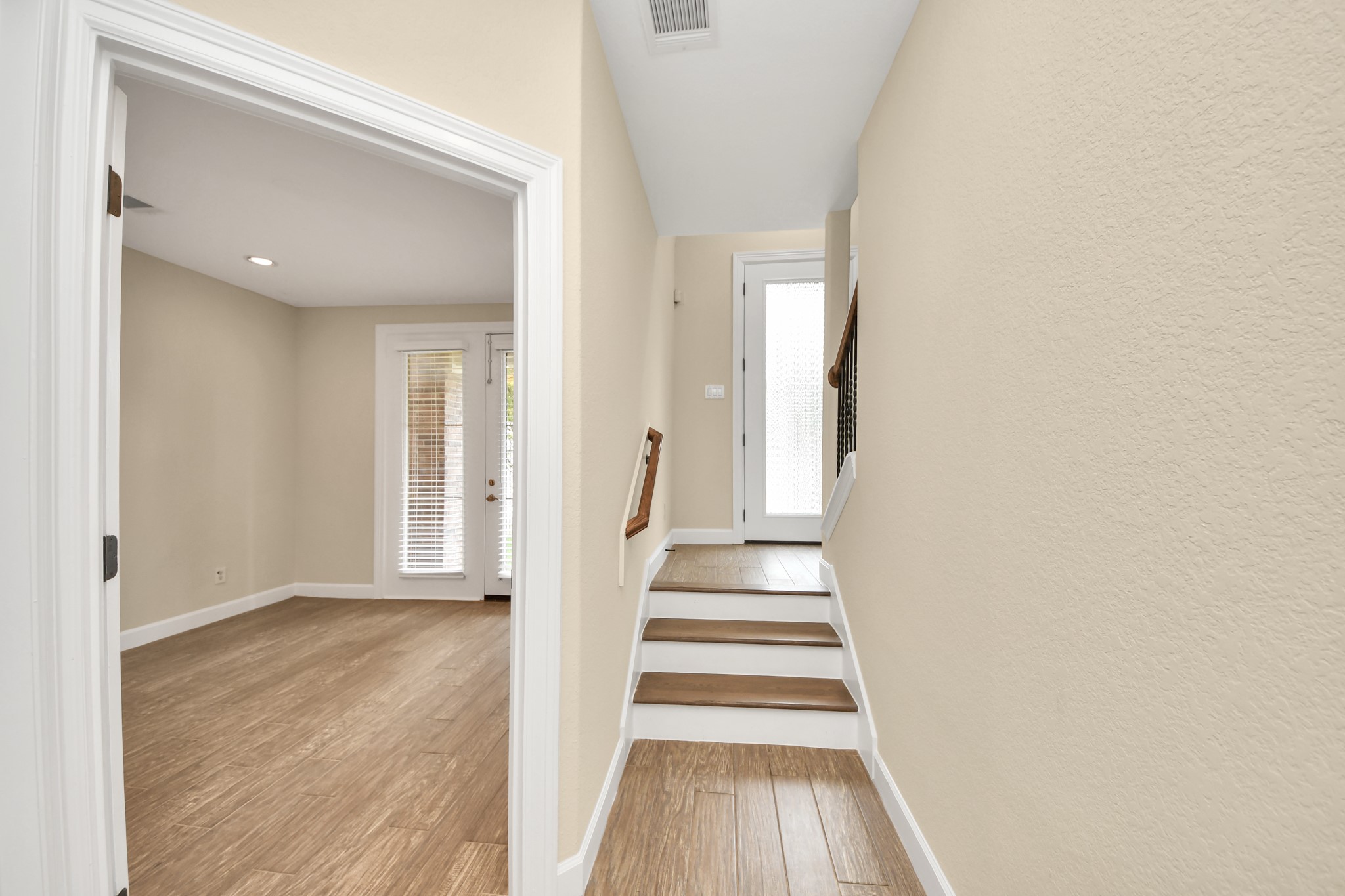 2830 Polk Street Houston, TX 77003 - Photo 3 of 21 Crisp neutral tones, extended baseboards, and wood-look tile flooring create a clean, elevated feel from the moment you step inside.