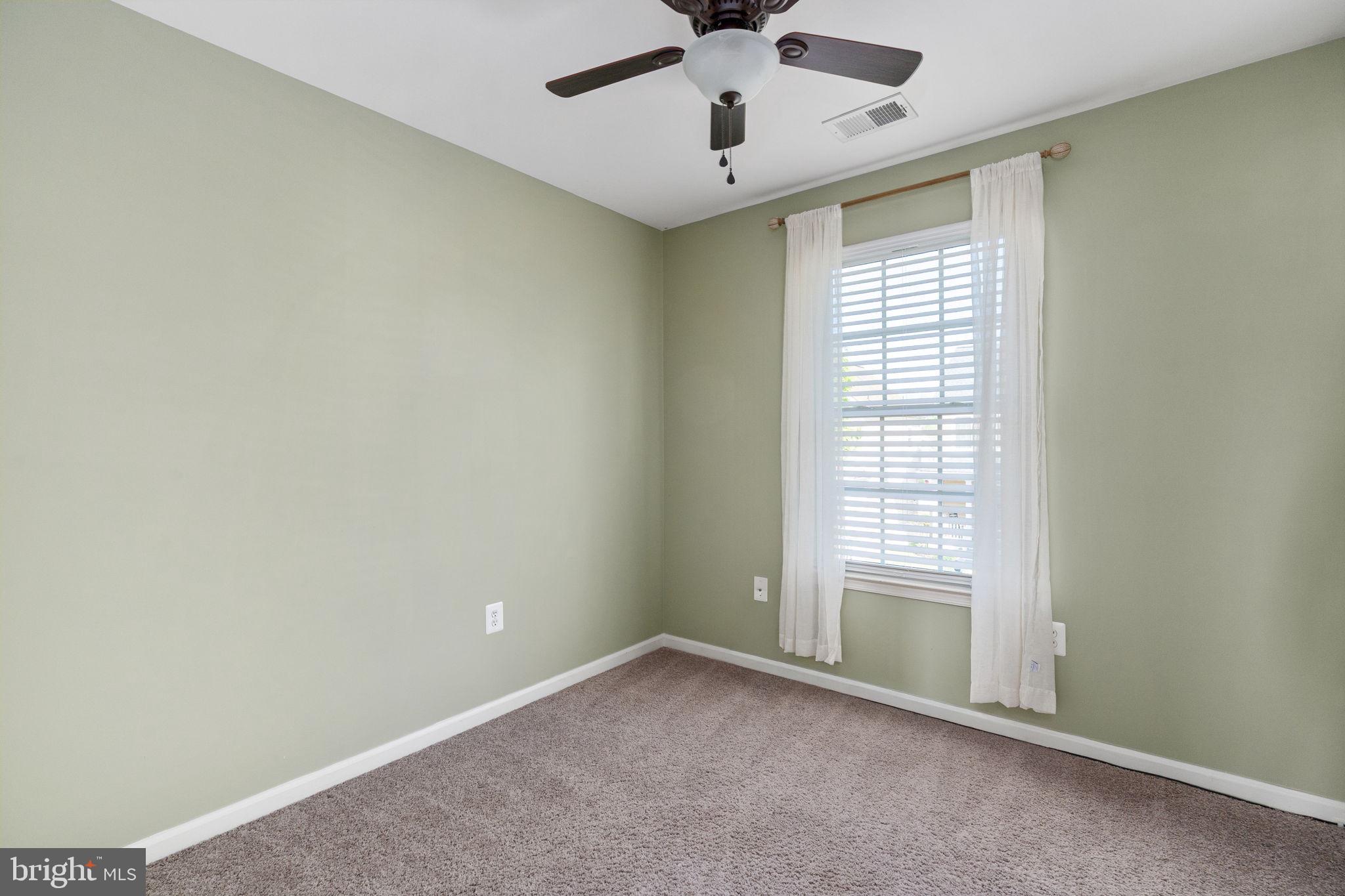 7124 Azalea Drive Ruther Glen, VA 22546 - Photo 28 of 43 an empty room with a window and ceiling fan