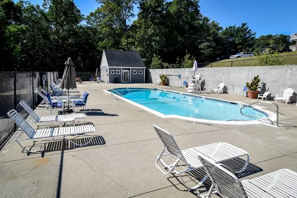 a view of a swimming pool with lounge chairs