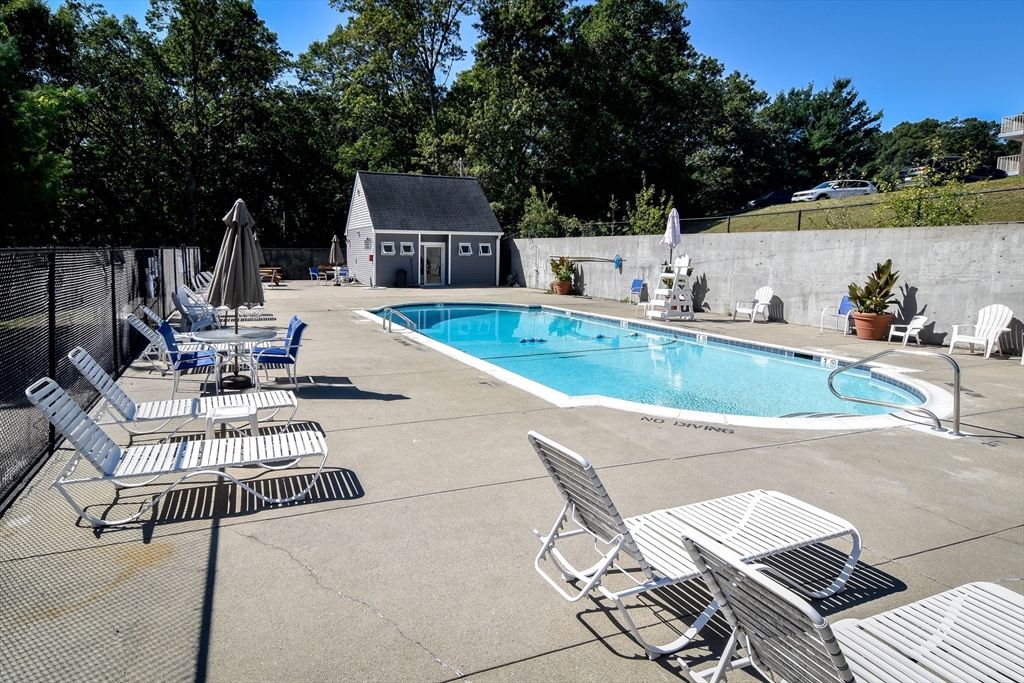 147 Turner Road, Unit 106 Holliston, MA 01746 - Photo 14 of 16 a view of a swimming pool with lounge chairs