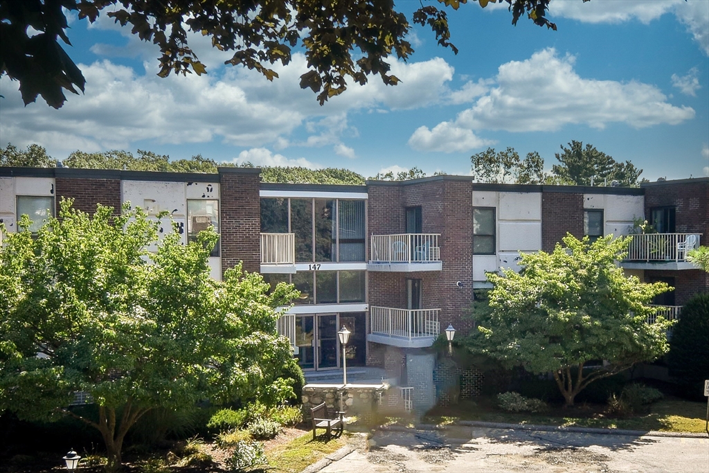 147 Turner Road, Unit 106 Holliston, MA 01746 - Photo 16 of 16 a view of a building with a garden