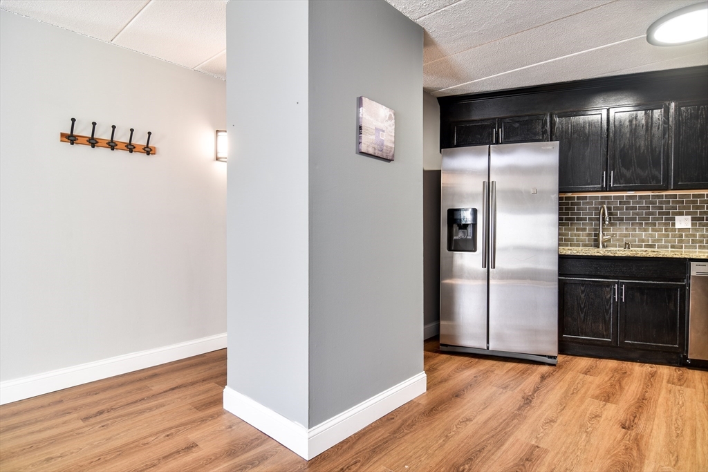 147 Turner Road, Unit 106 Holliston, MA 01746 - Photo 4 of 16 a view of an empty room with kitchen and a window