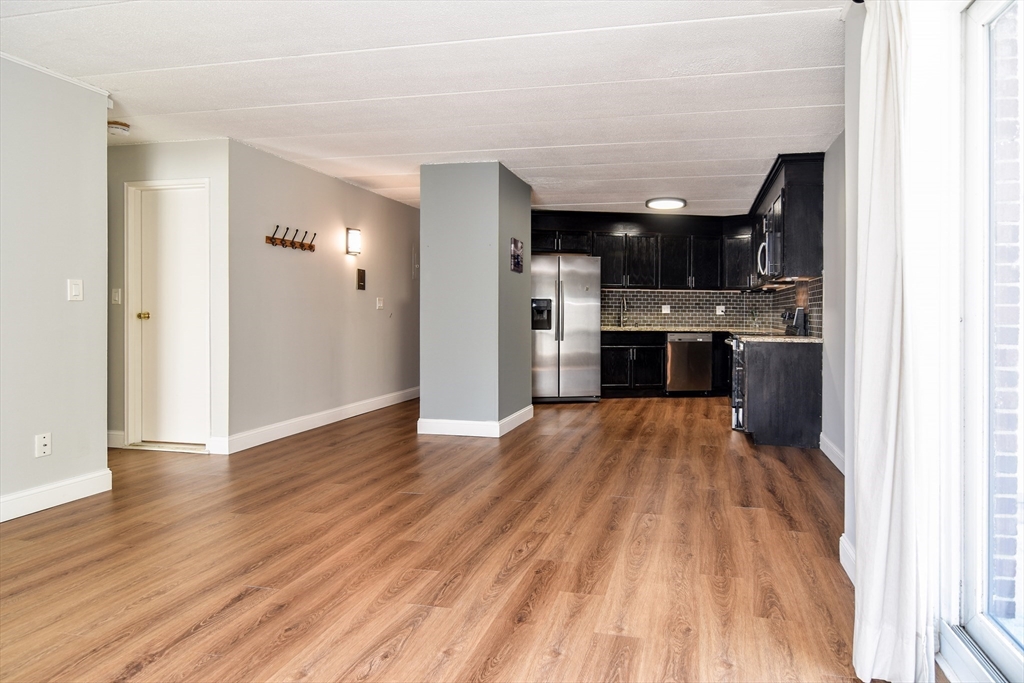 147 Turner Road, Unit 106 Holliston, MA 01746 - Photo 5 of 16 a view of kitchen and wooden floor