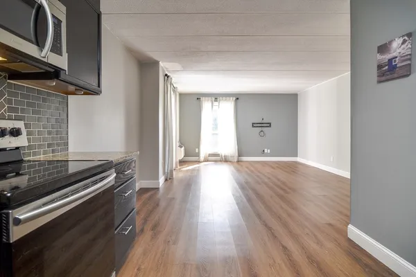 a view of an empty room and wooden floor