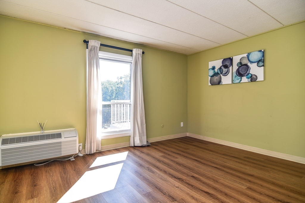 147 Turner Road, Unit 106 Holliston, MA 01746 - Photo 10 of 16 a view of a room with wooden floor and bench