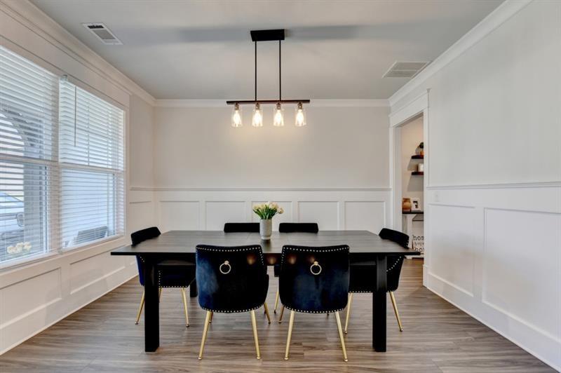 148 Logan Pass Drive Loganville, GA 30052 - Photo 12 of 103 a view of a dining room with furniture and wooden floor
