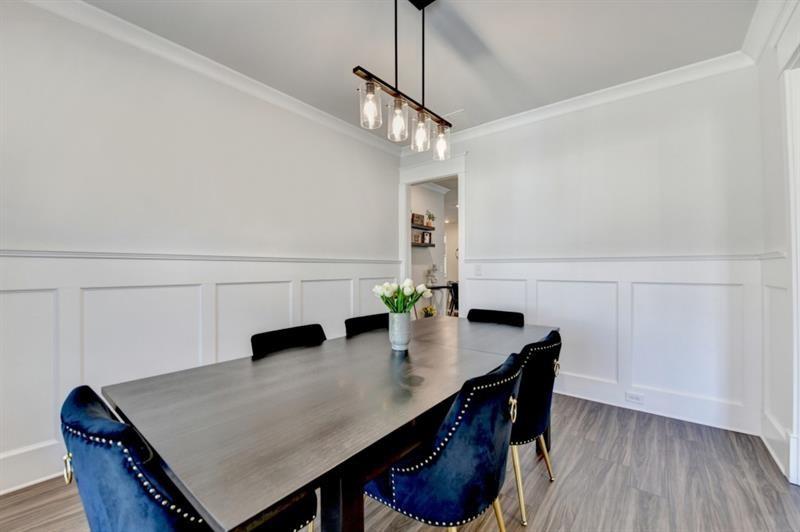 148 Logan Pass Drive Loganville, GA 30052 - Photo 14 of 103 a view of a dining room with furniture and wooden floor
