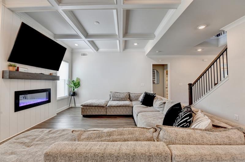 148 Logan Pass Drive Loganville, GA 30052 - Photo 19 of 103 a living room with furniture and a flat screen tv