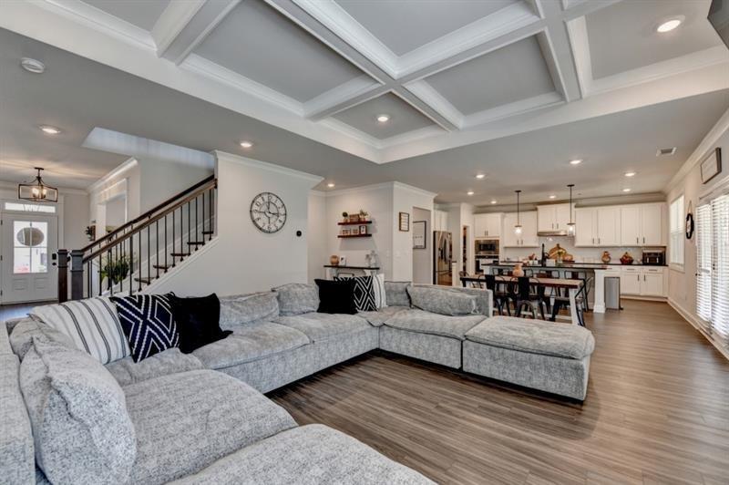 148 Logan Pass Drive Loganville, GA 30052 - Photo 23 of 103 a living room with furniture kitchen view and a wooden floor