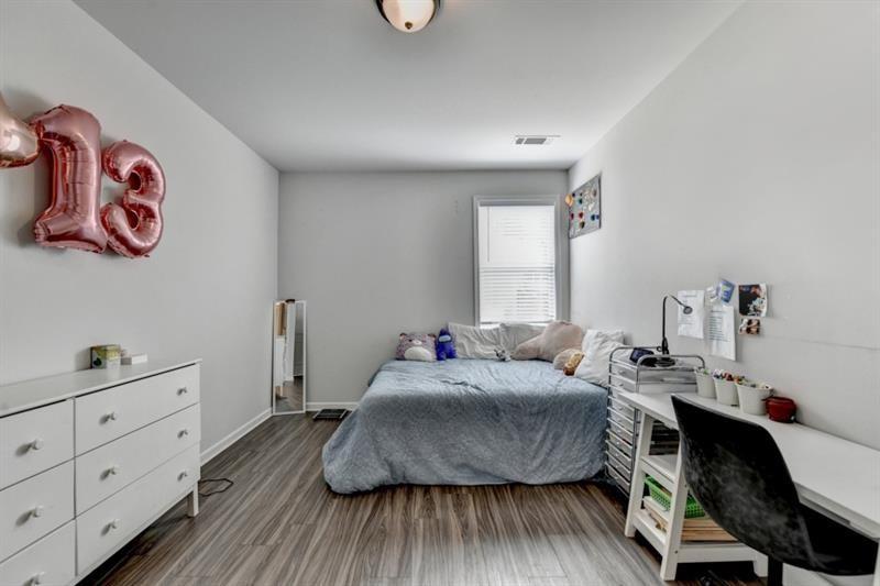 148 Logan Pass Drive Loganville, GA 30052 - Photo 36 of 103 a bedroom with a bed and a dresser
