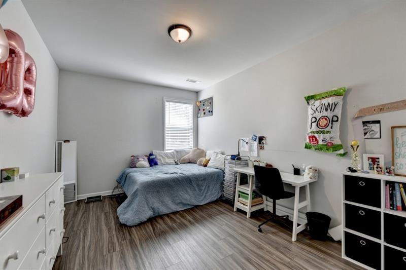 148 Logan Pass Drive Loganville, GA 30052 - Photo 38 of 103 a living room with furniture and a wooden floor