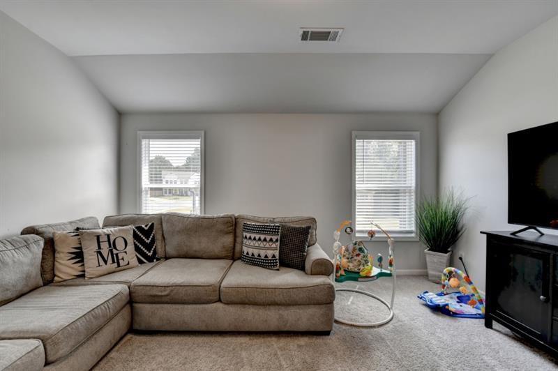 148 Logan Pass Drive Loganville, GA 30052 - Photo 42 of 103 a living room with furniture and a flat screen tv