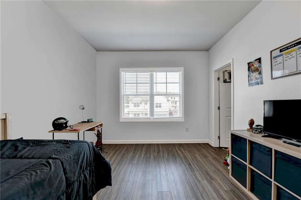 148 Logan Pass Drive Loganville, GA 30052 - Photo 63 of 103 a bedroom with a bed and a tv on the dresser