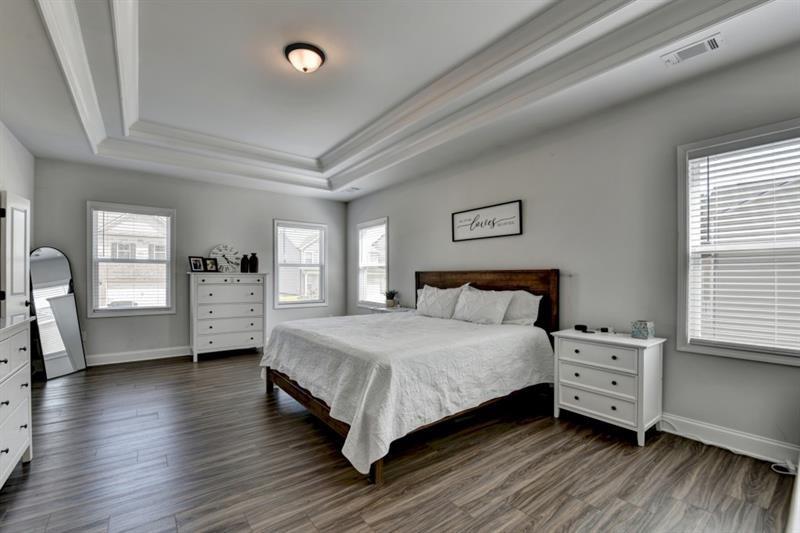 148 Logan Pass Drive Loganville, GA 30052 - Photo 70 of 103 a spacious bedroom with a bed and a large window