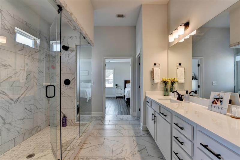 148 Logan Pass Drive Loganville, GA 30052 - Photo 76 of 103 a spacious bathroom with a double vanity sink mirror and shower