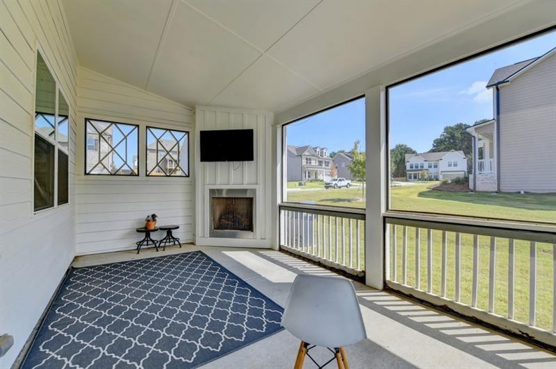 148 Logan Pass Drive Loganville, GA 30052 - Photo 81 of 103 a living room with furniture a fireplace and a flat screen tv