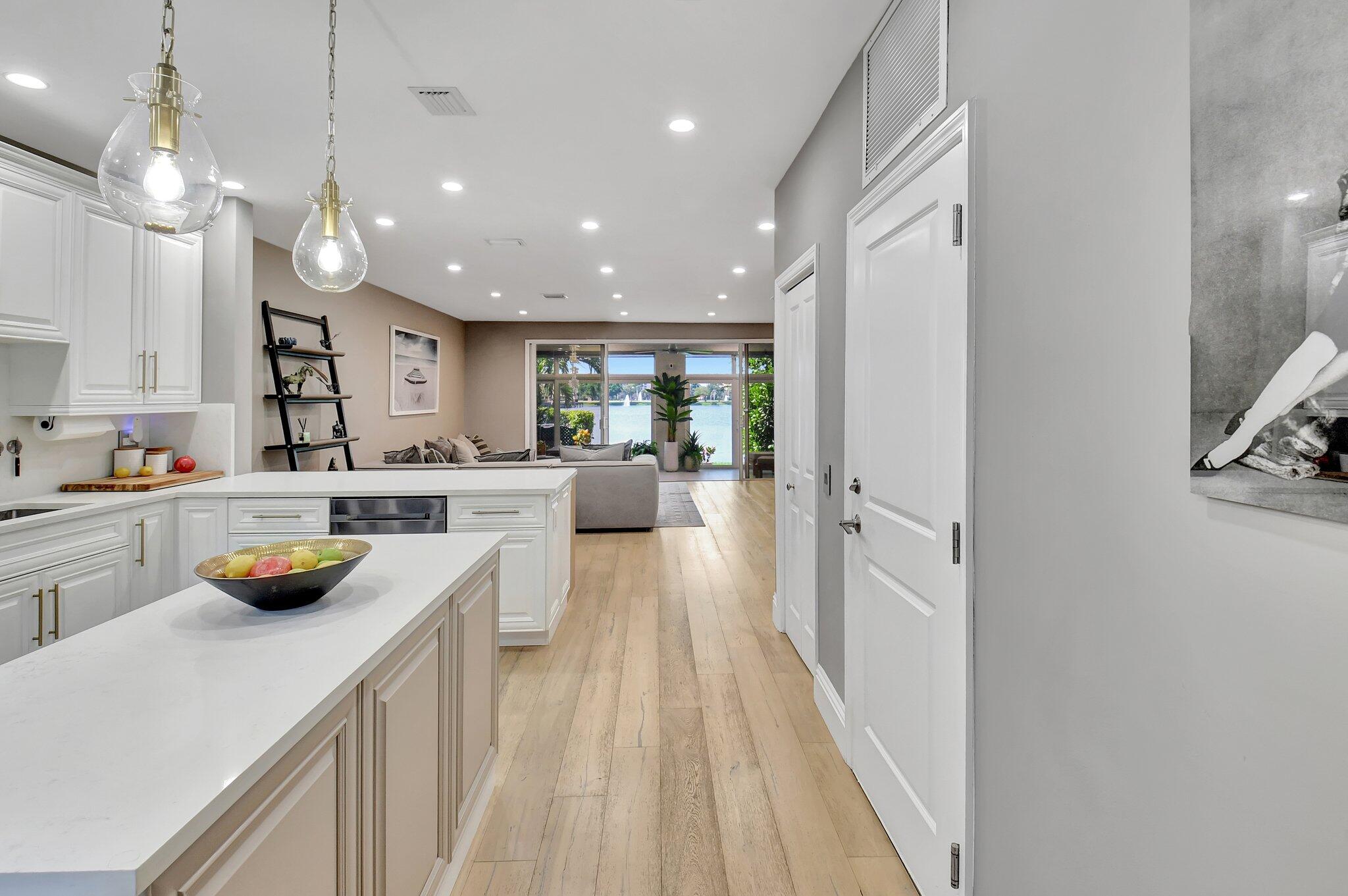6795 Via Regina Boca Raton, FL 33433 - Photo 12 of 83 a kitchen with counter top space a sink appliances and cabinets