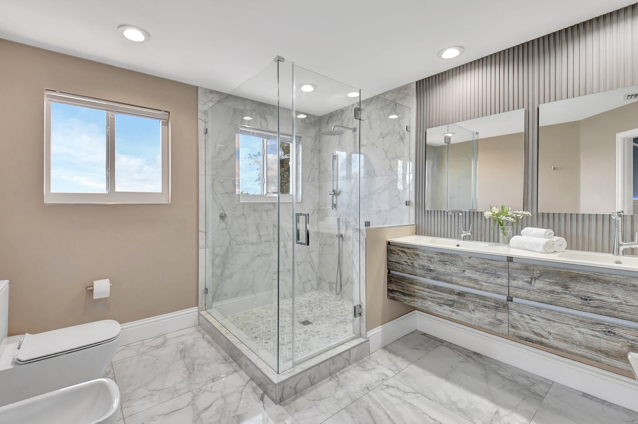 6795 Via Regina Boca Raton, FL 33433 - Photo 31 of 83 a bathroom with a shower sink and mirror