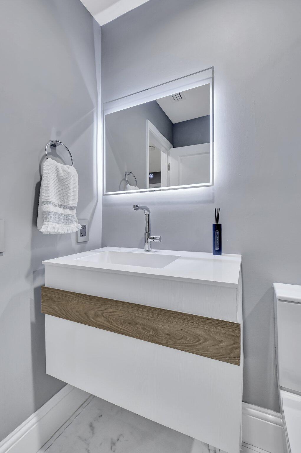 6795 Via Regina Boca Raton, FL 33433 - Photo 37 of 83 a bathroom with a sink and a mirror