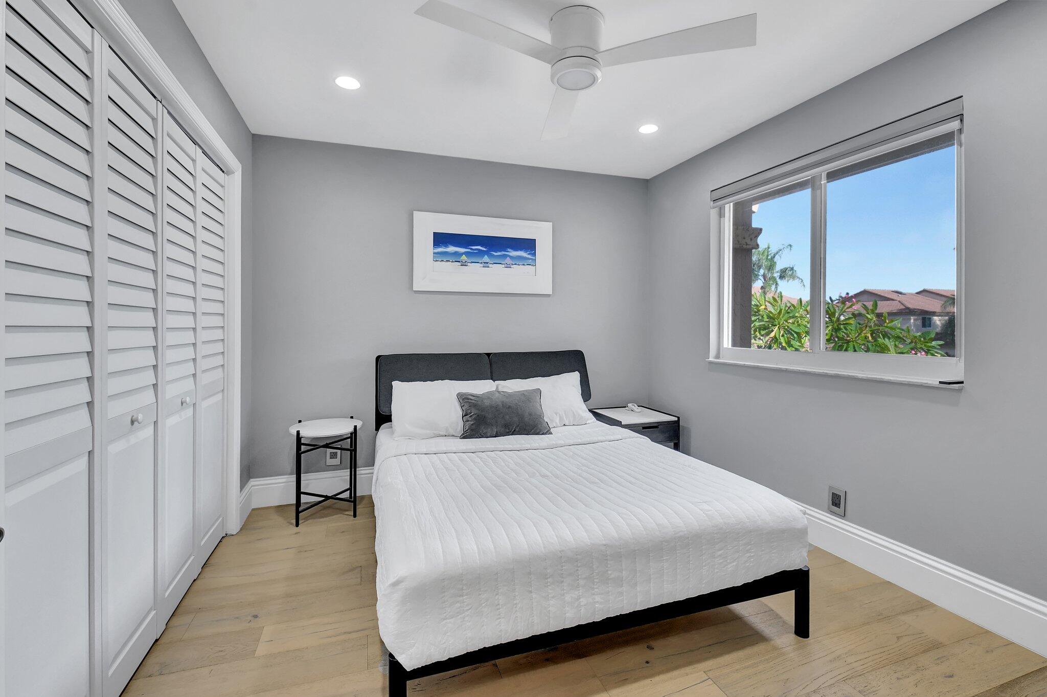 6795 Via Regina Boca Raton, FL 33433 - Photo 39 of 83 a bedroom with a bed and a painting on the wall