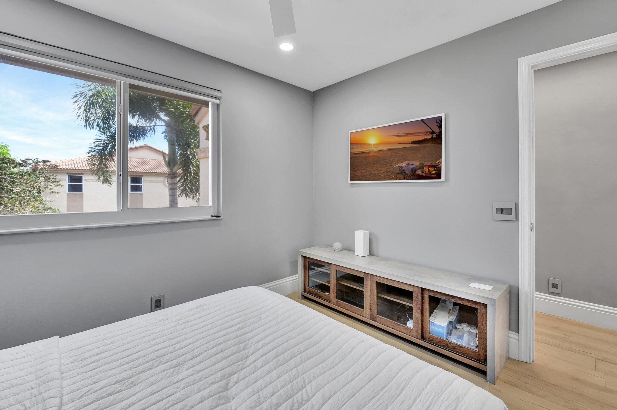 6795 Via Regina Boca Raton, FL 33433 - Photo 40 of 83 a bedroom with a bed and a painting on the wall