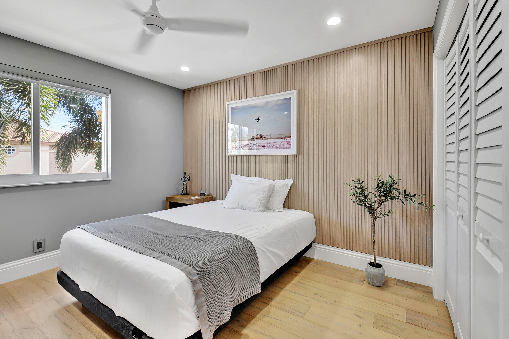 6795 Via Regina Boca Raton, FL 33433 - Photo 43 of 83 a bedroom with a large bed and a potted plant