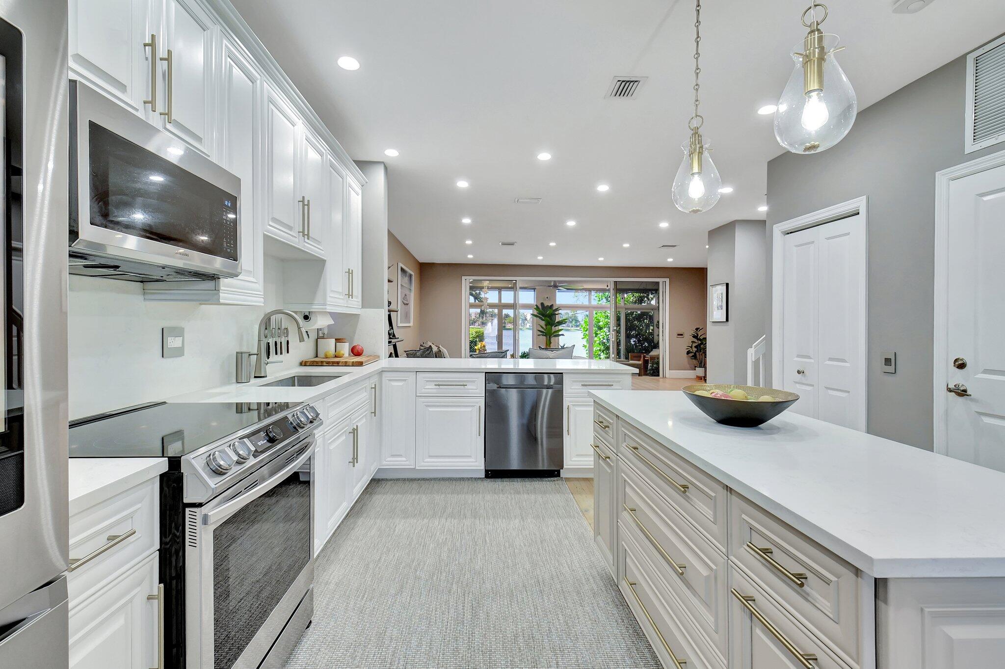 6795 Via Regina Boca Raton, FL 33433 - Photo 9 of 83 a kitchen with a sink stainless steel appliances and cabinets