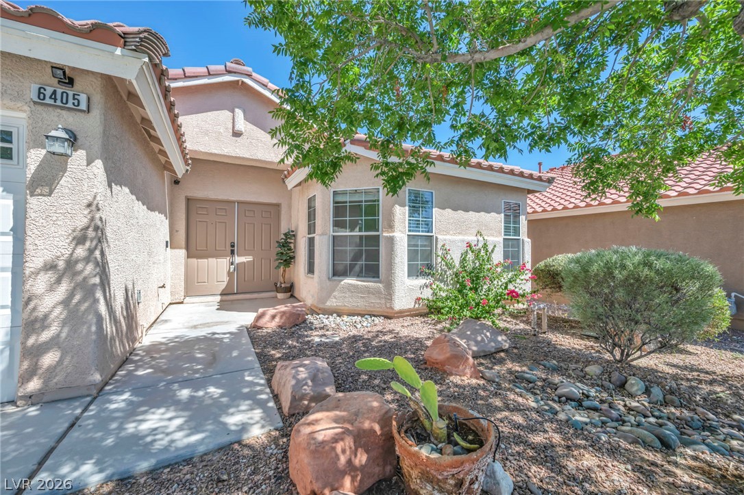 6405 North Raptor Court North Las Vegas, NV 89084 - Photo 52 of 66 A desert-inspired landscape provides a welcoming approach to this property, featuring a sturdy tiled roof and textured stucco exterior.