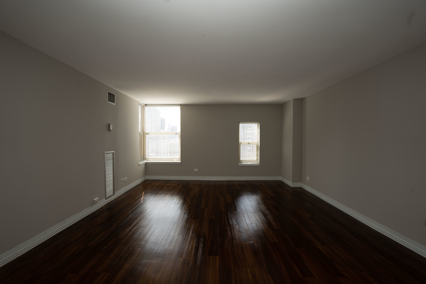 100 West Chestnut Street, Unit 2505 Chicago, IL 60610 - Photo 11 of 13 a view of an empty room with wooden floor and window