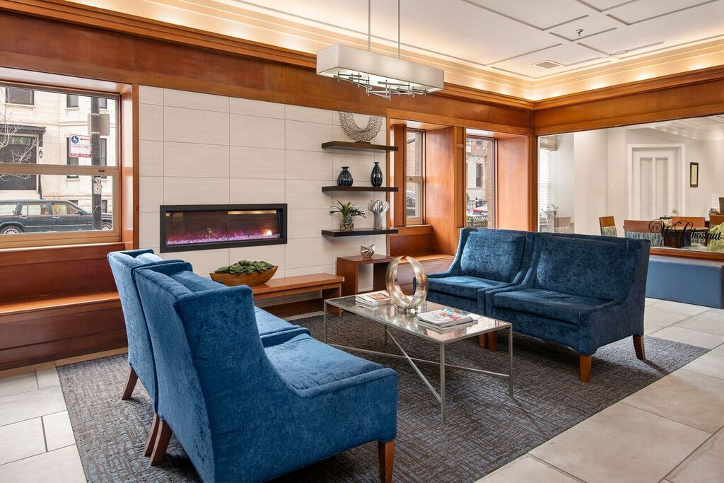 100 West Chestnut Street, Unit 2505 Chicago, IL 60610 - Photo 5 of 13 a living room with furniture a fireplace and a window