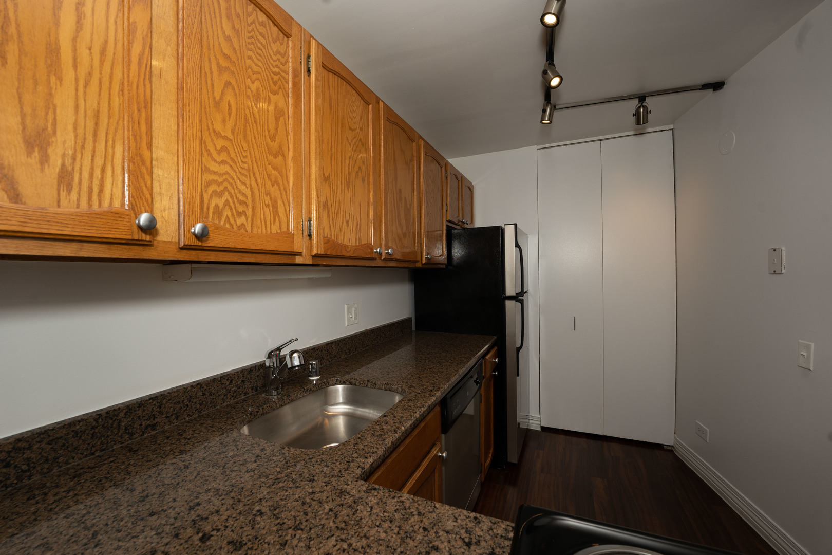 100 West Chestnut Street, Unit 2505 Chicago, IL 60610 - Photo 10 of 13 a kitchen with granite countertop cabinets and refrigerator