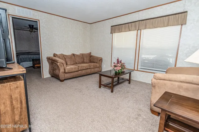 a dining room with stainless steel appliances kitchen island granite countertop furniture and wooden floor