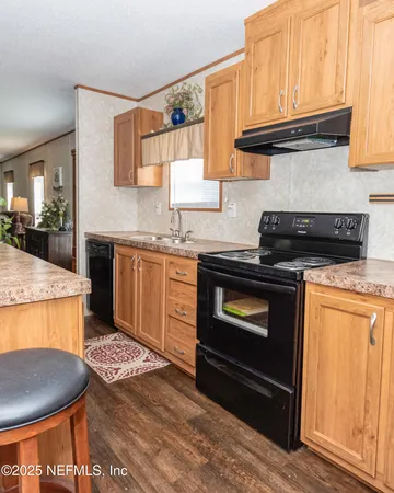 a kitchen with granite countertop a stove and a sink