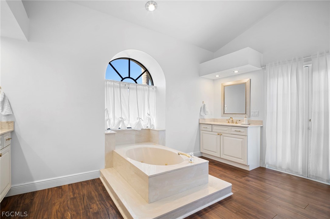 11772 Mahogany Run Fort Myers, FL 33913 - Photo 40 of 50 a spacious bathroom with a tub a sink and a window