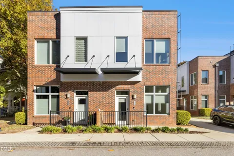 a front view of a residential apartment building with a yard